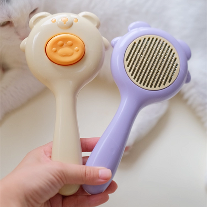 Cepillo para mascotas estilo osito con botón de autolimpieza