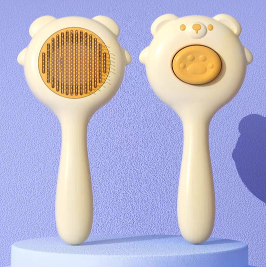 Cepillo para mascotas estilo osito con botón de autolimpieza